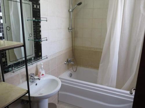 a bathroom with a sink and a tub and a shower at The view studio in Hurghada
