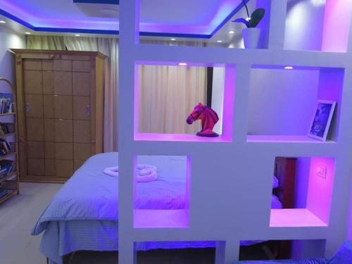 a room with a bed with a purple lighting at The view studio in Hurghada