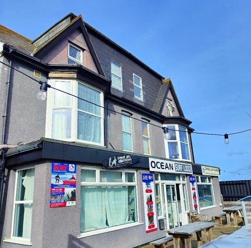 a building with an open sign on the front of it at Ocean Surf lodge in Newquay
