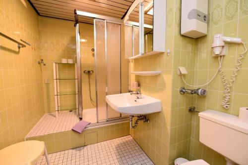 a bathroom with a sink and a shower at Haus "Panorama" Appartement PAN105 in Duhnen