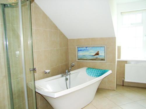 a bathroom with a bath tub and a shower at Glendalough 10 Minutes from Beautiful Farmhouse in Roundwood