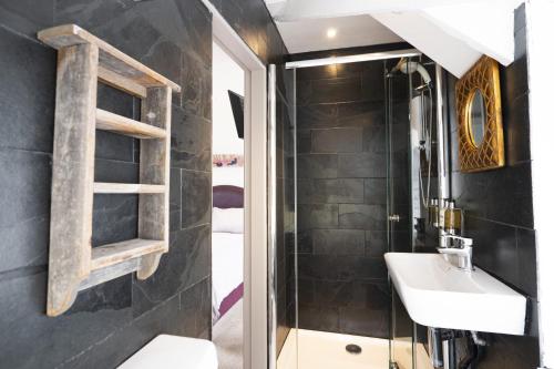 a bathroom with a sink and a mirror at Cornerways Guest House in St Ives