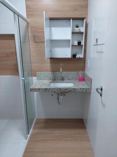 ein Badezimmer mit Waschbecken und Dusche in der Unterkunft Ótimo apartamento sobreloja com wifi e estacionamento incluso in Maringá