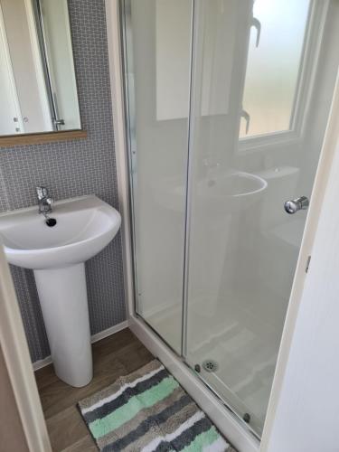a bathroom with a sink and a shower at Mawgan Pads Perranporth in Cubert