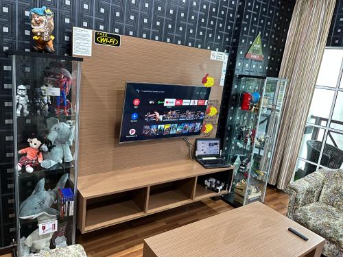 a room with a flat screen tv on a wall at EagleNest at Iris House Resort in Tanah Rata