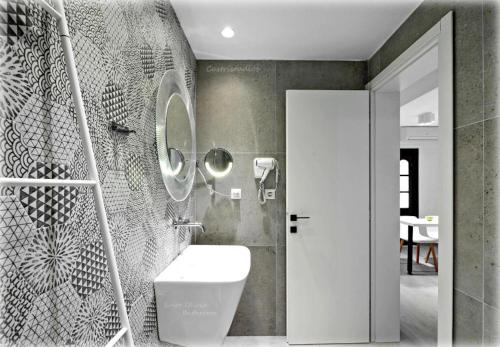 a bathroom with a toilet and a mirror at Castristudios in Nikiti