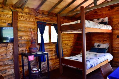 a bedroom with two bunk beds in a log cabin at Castillo Casablanca in Guatavita