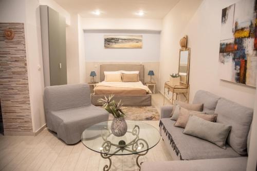 a living room with a bed and a couch and a table at Mediterranean in Preveza