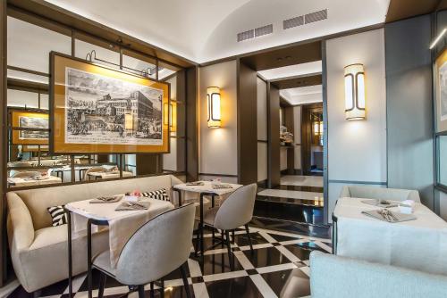 a restaurant with two tables and chairs in a room at Hotel Lunetta in Rome