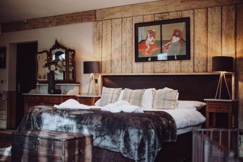 a bedroom with a large bed and a mirror at South Causey Inn in Stanley