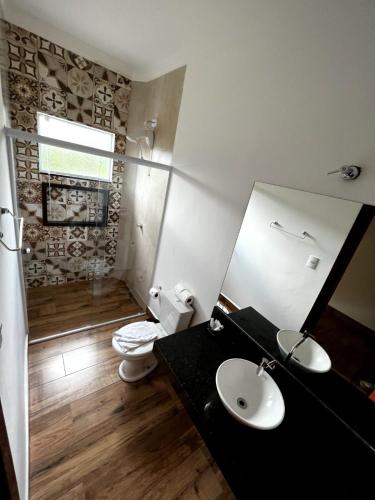 a bathroom with a sink and a toilet at Hotel Fazenda Vale da Cachoeira in Serra Negra