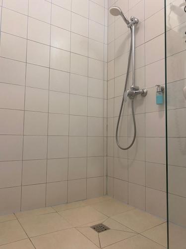 a bathroom with a shower with a glass door at Hotel Kolumbs in Liepāja