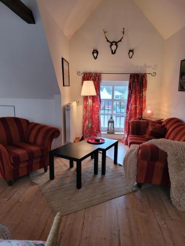 a living room with a couch and a table at Gut Basthorst in Basthorst