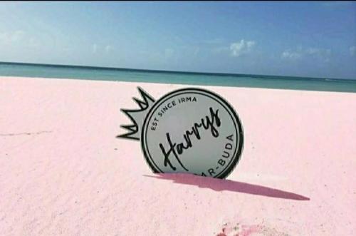 a drawing of a sign on a pink beach at Harrys Cottage 4 in Dulcina