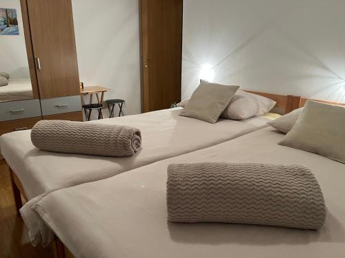 two beds sitting next to each other in a bedroom at Holiday Home Božica in Ličko Lešće