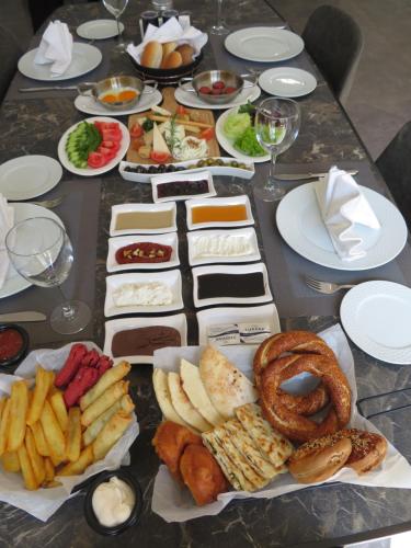a table with many different types of food on it at Hotel Sun in North Nicosia