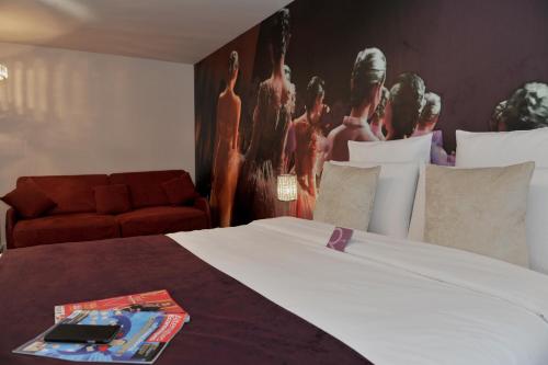 a bedroom with a bed and a painting on the wall at Mercure Paris Place d'Italie in Paris