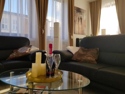 a living room with a couch and a glass table at Apartment Deluxe, inklusive WLAN, Parkplatz und Netflix in Schleiden