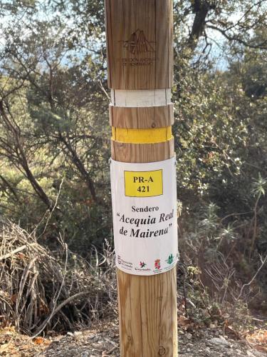 a wooden pole with a sign on it at Apartamentos El Cabo in Mairena
