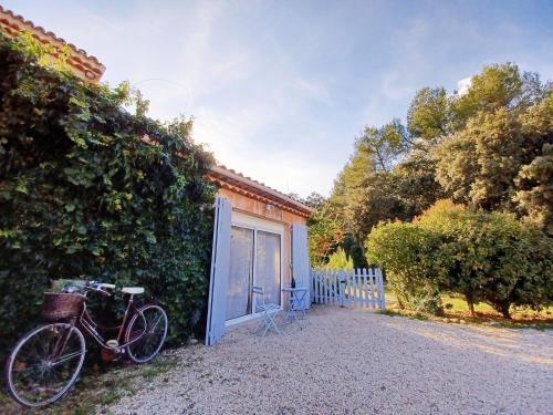 a bike parked next to a building with a garage at Studio avec jardin entre Aix-en-Provence, Luberon et Verdon in Peyrolles-en-Provence