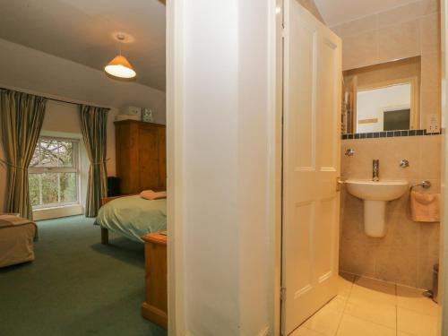 a bathroom with a sink and a toilet in a room at The Old Vicarage in Thirlmere