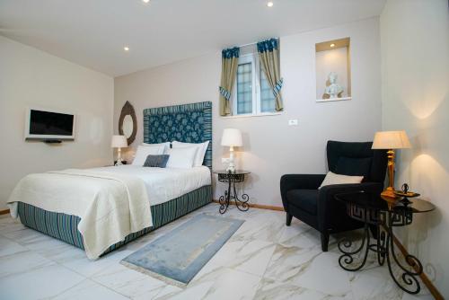 a hotel room with a bed and a chair at Boutique Guest Accommodation Zephyrus in Split