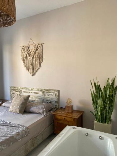 a bedroom with a bed and a bath tub at Bardot Hostel in Paraná