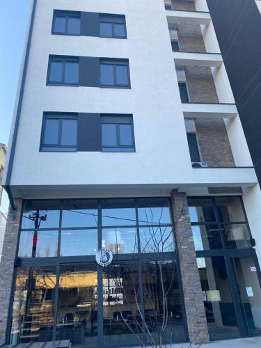 a building with a reflection in the windows at Bella Vita Dorćol in Belgrade