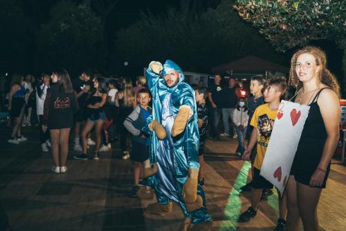 a group of people dressed in costumes at a party at ISOLA VERDE Camping Village in Nettuno