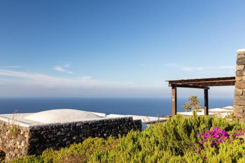 a view of the ocean from a house at Pantelleria Dream Resort in Pantelleria