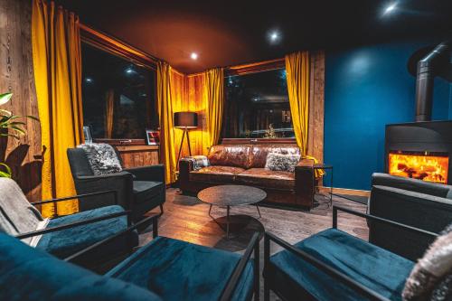 a living room with a couch and a fireplace at Hotel Du Lac in Montriond