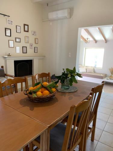 a dining room table with a bowl of fruit on it at EY House in Halikounas