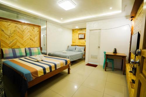 Postel nebo postele na pokoji v ubytování JEMZ Tagaytay Budget Transient