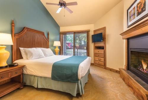 a bedroom with a bed and a fireplace at WorldMark Galena in Galena