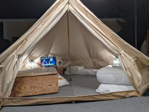 a tent with a bed and a television in it at Camping San Javier in San Javier