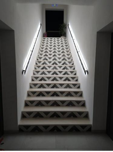 a staircase in a building with white walls and lights at Asimina Suites in Nikiti