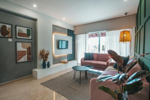 a living room with a couch and a table at Designer 2-Bedroom Apartment 150m from Mackenzie Beach in Larnaca