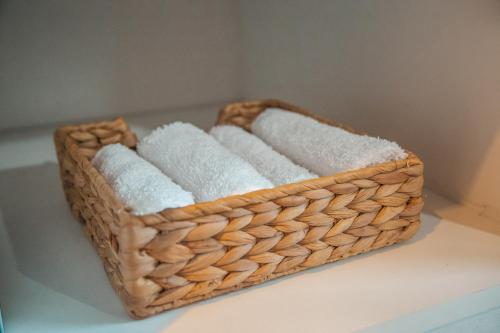 a basket filled with towels sitting on a table at Designer 2-Bedroom Apartment 150m from Mackenzie Beach in Larnaca