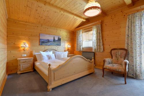 a bedroom with a bed and a chair in a room at Ferienwohnung Scheffau in Scheffau am Wilden Kaiser