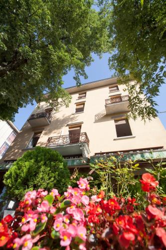 a building with flowers in front of it at Hotel Ristorante San Carlo in Salsomaggiore Terme