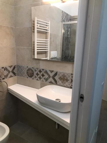 a bathroom with a sink and a mirror at Appartamenti La Nina & La Nzina in Otranto