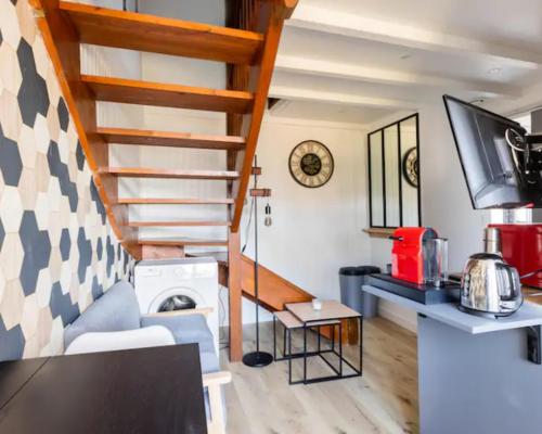a room with a staircase and a living room at Appartement T2- Le bon accueil / WIFI / PARKING in Angoulême