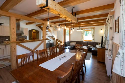 a dining room and living room with a table and chairs at Chalet Pr Dobravc in Bohinj