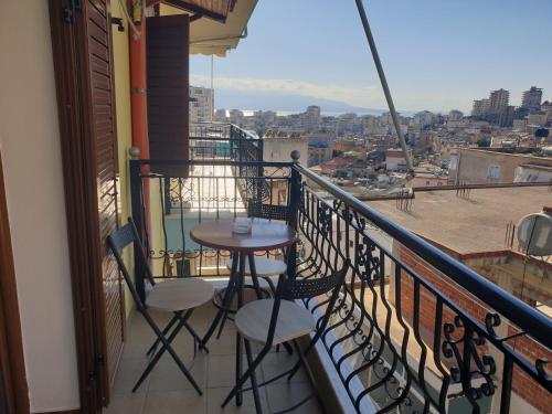 a table and chairs on a balcony with a view at Apartment Rina in Sarandë