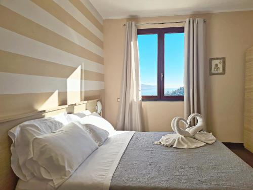 a bedroom with a bed with a heart towel on it at Agriturismo La Pietra 1 e La Pietra 2 in La Spezia