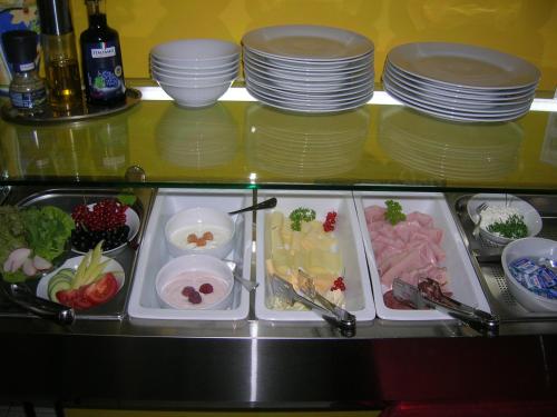 a buffet with plates and food on a table at Casa Andelka in Andělská Hora