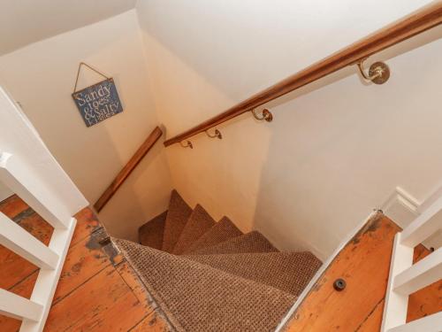 a staircase in a house with a wooden floor at But `n' Ben in Whitby
