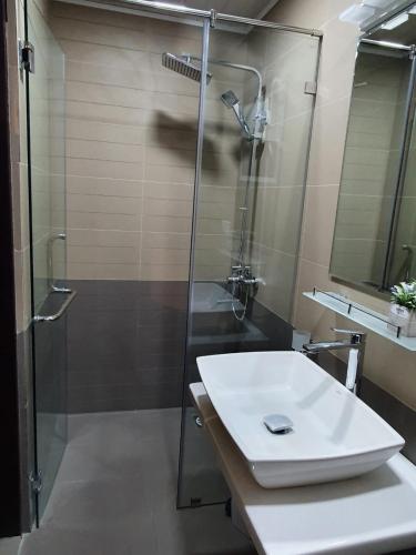 a bathroom with a glass shower and a sink at The Edge Luxury Apartment in Nuwara Eliya