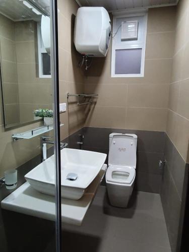 a bathroom with a toilet and a sink at The Edge Luxury Apartment in Nuwara Eliya