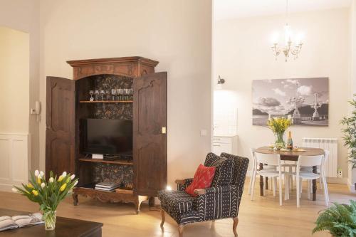 a living room with a television and a dining room table at MARITXU'S HOME in Donostia-San Sebastián